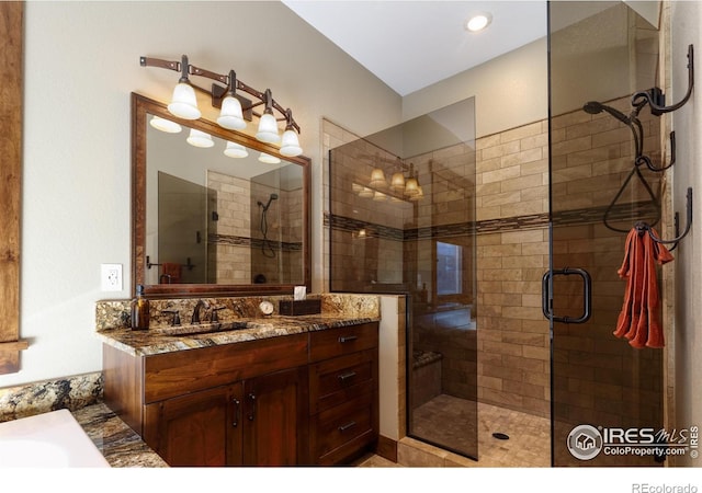 bathroom featuring vanity and an enclosed shower