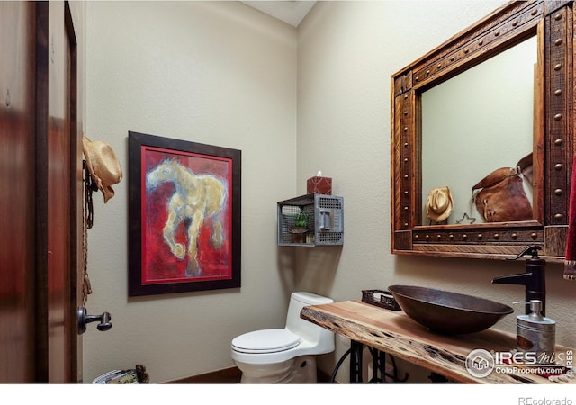 bathroom featuring sink and toilet