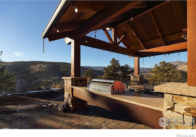 view of patio / terrace featuring a gazebo, a mountain view, area for grilling, and grilling area