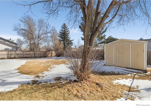 snowy yard with a shed