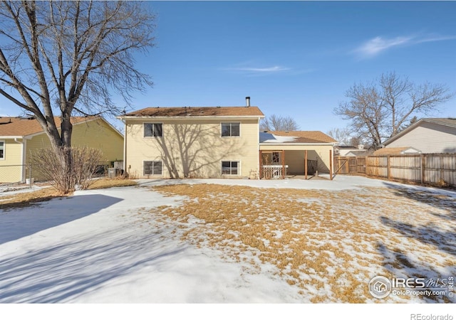 view of snow covered rear of property