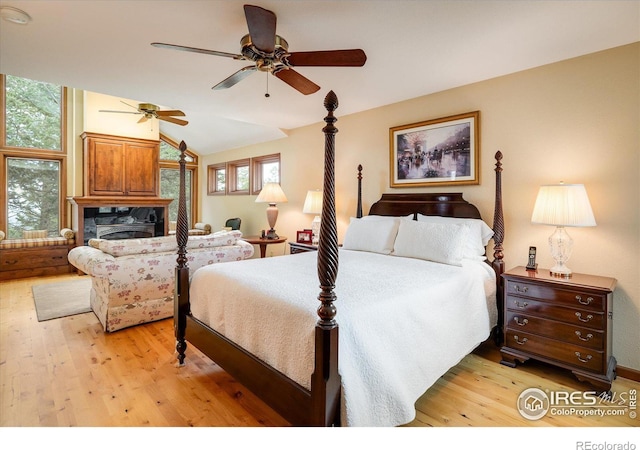 bedroom with lofted ceiling and light hardwood / wood-style floors