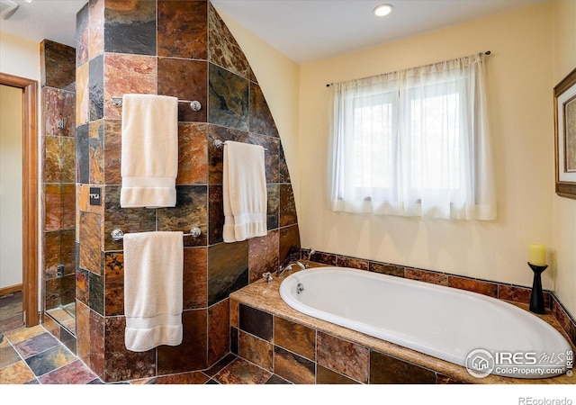 bathroom with shower with separate bathtub