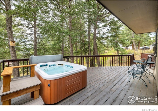 wooden deck with a hot tub