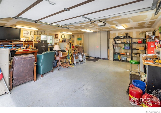 garage featuring a garage door opener and a workshop area