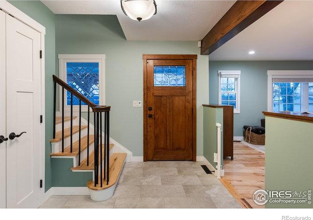 foyer with beamed ceiling