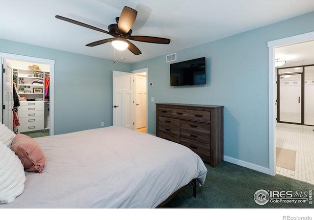 carpeted bedroom featuring a spacious closet, a closet, and ceiling fan