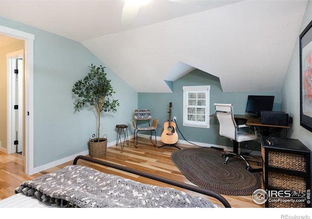 bedroom featuring wood-type flooring and vaulted ceiling