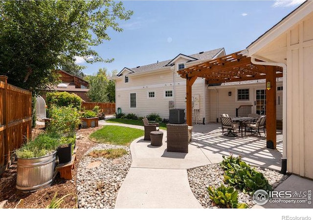 back of house with a pergola, a patio, and central air condition unit