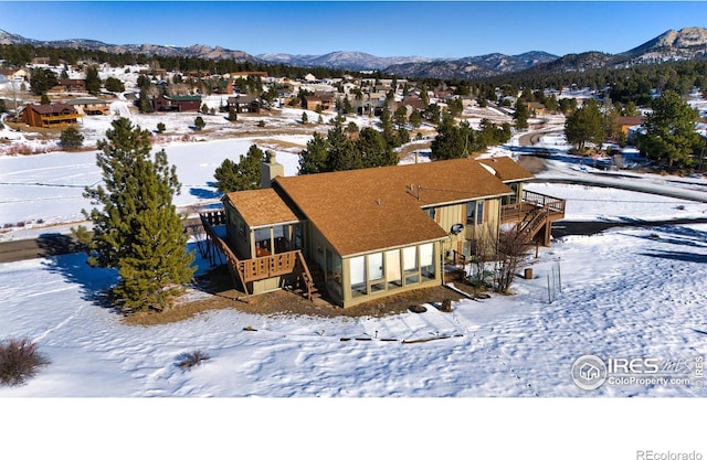 snowy aerial view featuring a mountain view