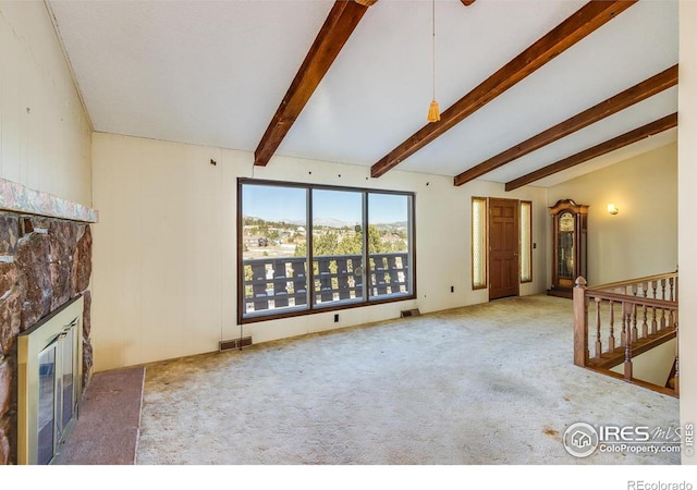 unfurnished living room featuring lofted ceiling with beams and carpet flooring