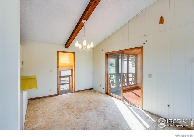 spare room with light colored carpet, lofted ceiling with beams, a chandelier, and a textured ceiling