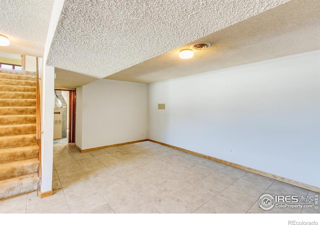 basement featuring a textured ceiling