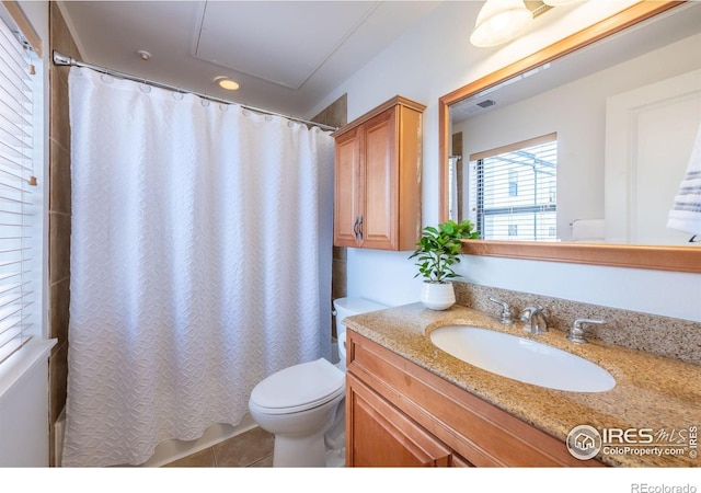 bathroom featuring vanity, tile patterned floors, and toilet