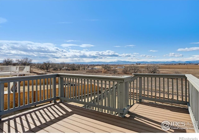 wooden terrace featuring a rural view