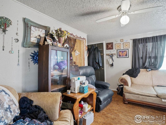 carpeted living room with ceiling fan and a textured ceiling