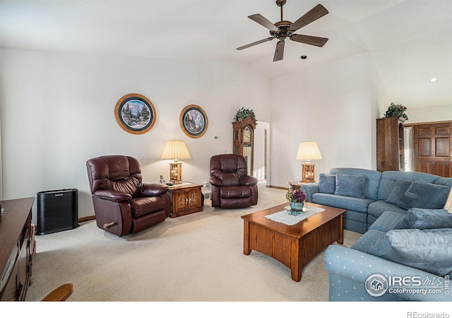 carpeted living room with vaulted ceiling and ceiling fan