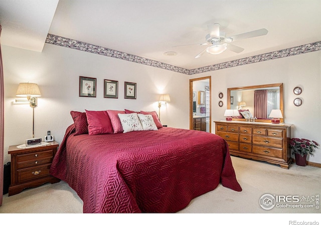 carpeted bedroom featuring ceiling fan and connected bathroom