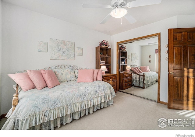 bedroom with ceiling fan, carpet, and a closet