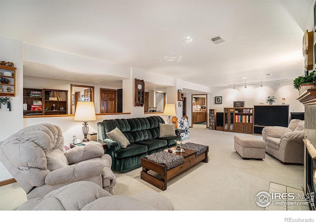 living room with light colored carpet and rail lighting