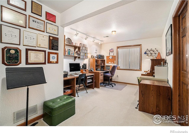 home office featuring light carpet and track lighting