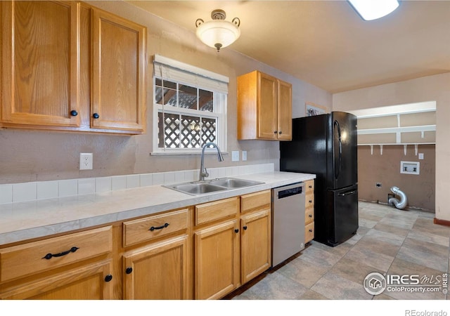 kitchen with dishwasher, black fridge, and sink