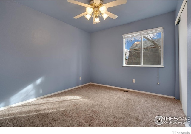 unfurnished room featuring ceiling fan and carpet floors