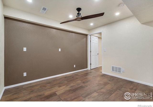 empty room featuring dark wood-type flooring and ceiling fan