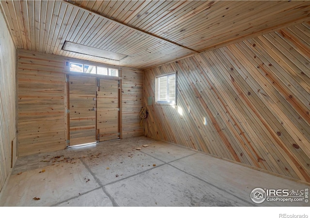 interior space with wooden ceiling and wooden walls