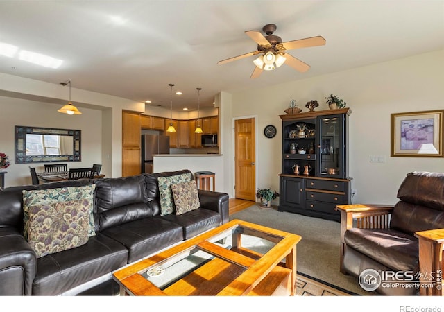 living room with carpet floors and ceiling fan