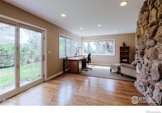 office featuring light wood finished floors, baseboards, and recessed lighting