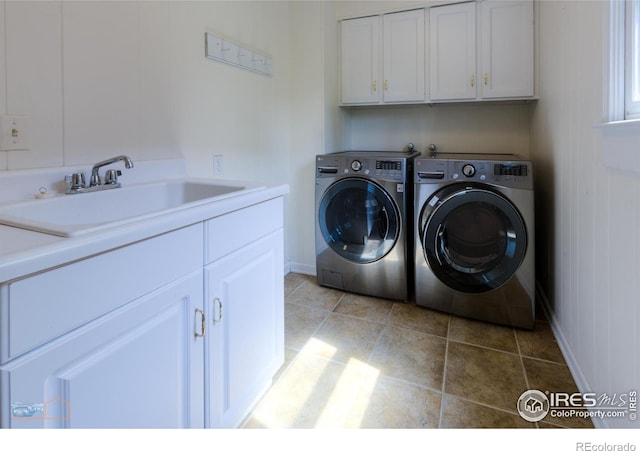 laundry room featuring cabinet space, washer and clothes dryer, and a sink