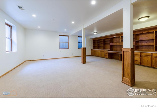 basement featuring visible vents, baseboards, light colored carpet, and recessed lighting