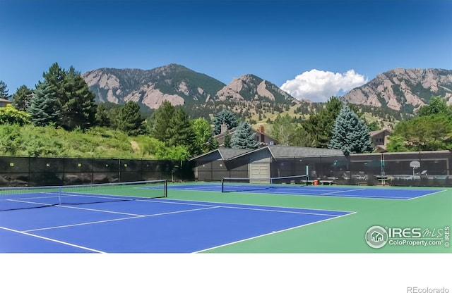 view of sport court with community basketball court, fence, and a mountain view