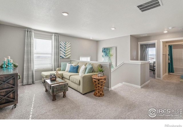 living room with light colored carpet and a textured ceiling