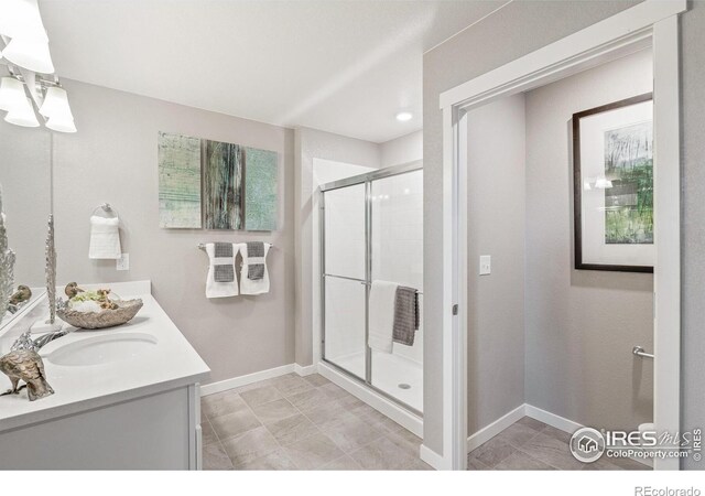 bathroom featuring vanity and an enclosed shower