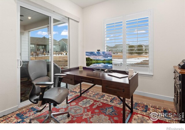 office space with wood-type flooring