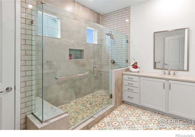 bathroom with an enclosed shower and vanity