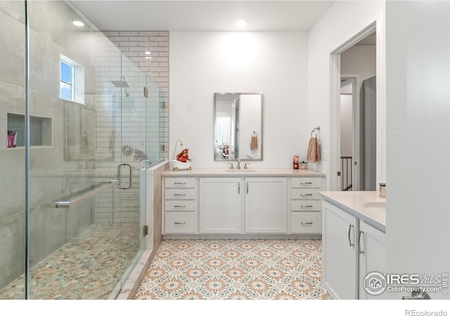 bathroom featuring walk in shower and vanity