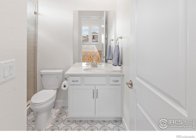 bathroom featuring vanity, tile patterned floors, and toilet