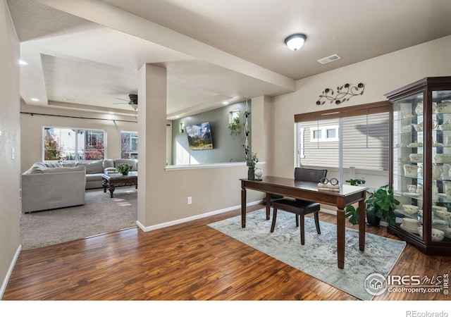 office space featuring dark hardwood / wood-style flooring and ceiling fan