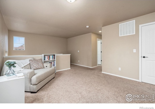 living area featuring light colored carpet