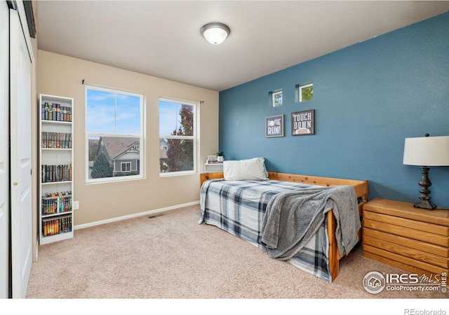 bedroom with light colored carpet