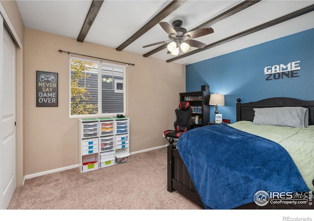 carpeted bedroom featuring beamed ceiling and ceiling fan