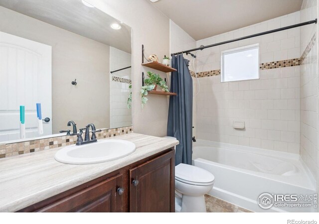 full bathroom with vanity, toilet, and shower / tub combo