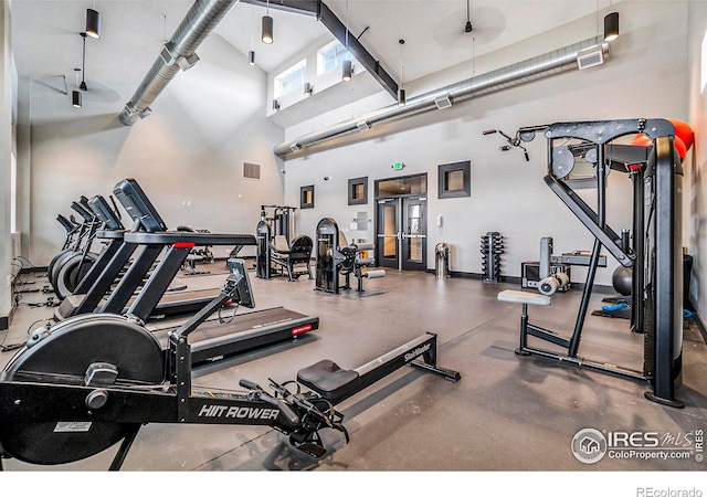 workout area with a towering ceiling