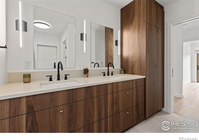 full bathroom featuring a sink and double vanity