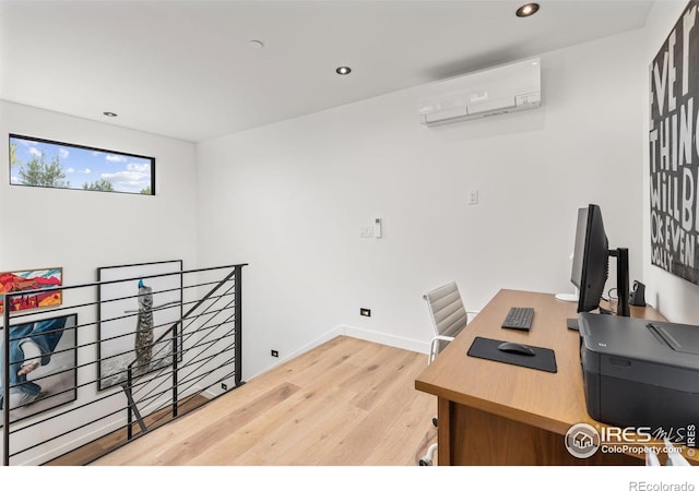 office featuring a wall mounted air conditioner and hardwood / wood-style floors