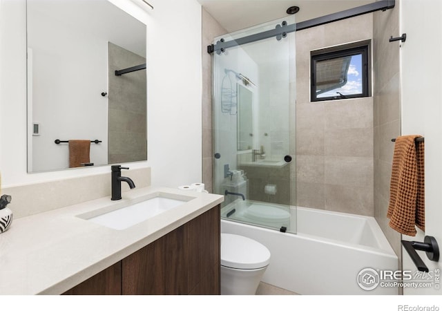 full bathroom with vanity, toilet, and combined bath / shower with glass door