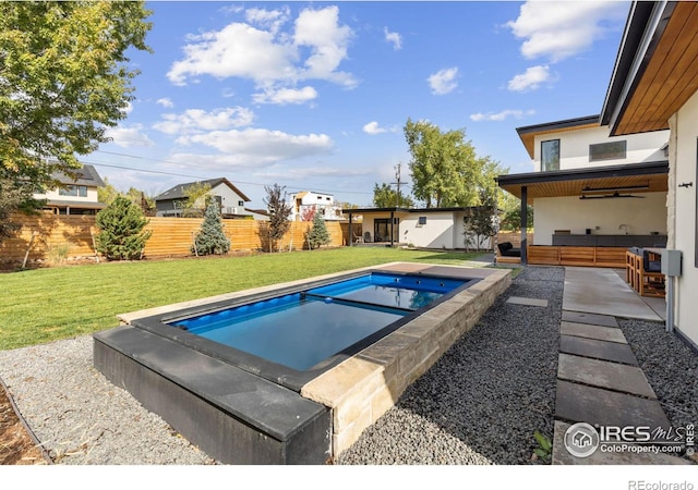 view of swimming pool with a patio area, fence, a fenced in pool, and a yard